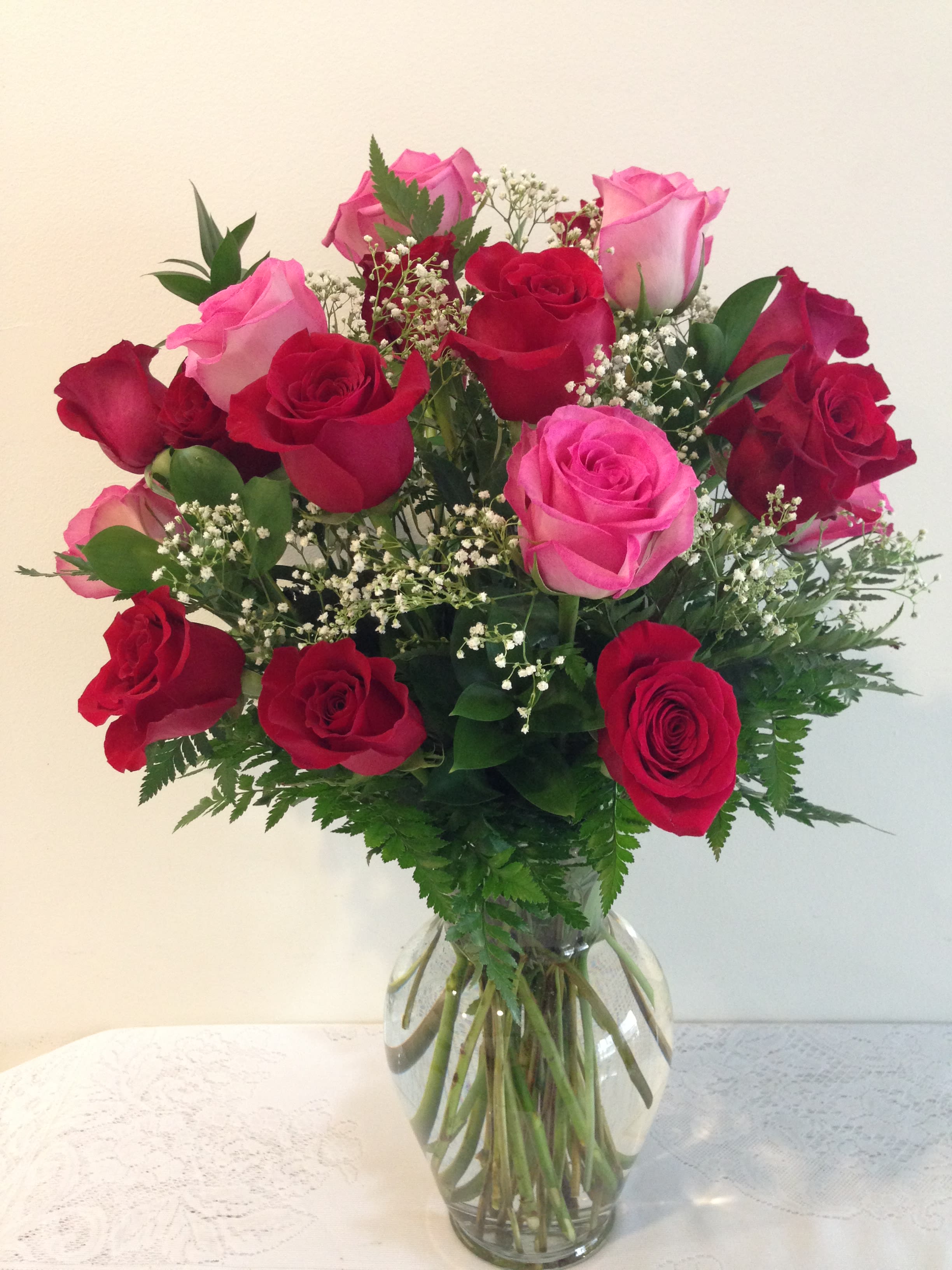 Bouquet of red and pink roses in a clear glass vase