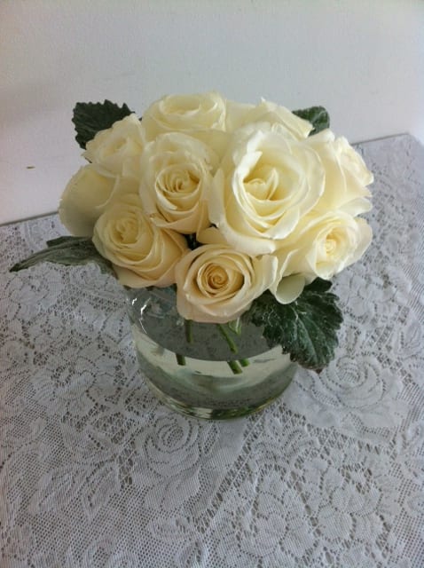 Cream rose bouquet in a clear glass vase