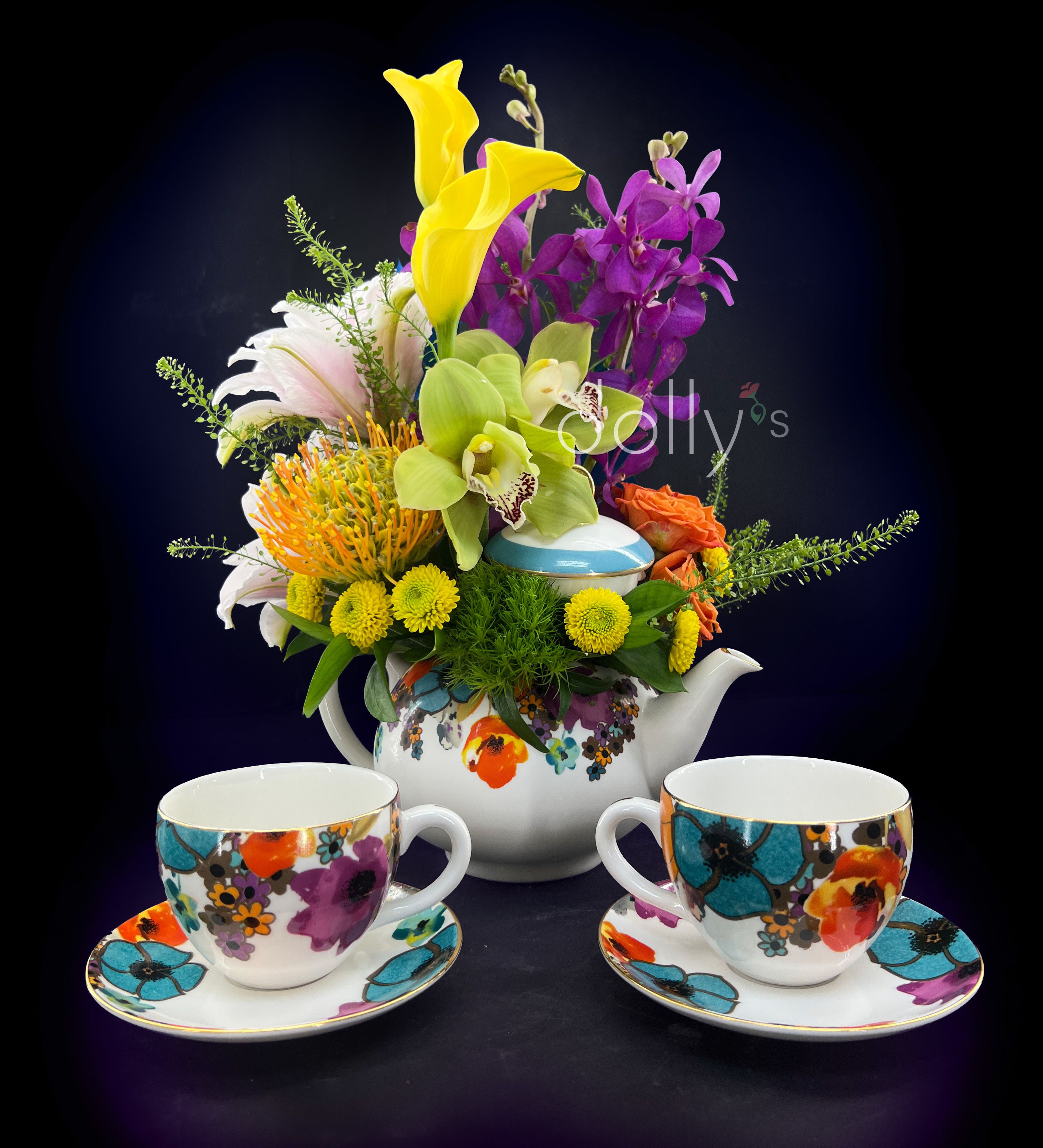 Lady Agatha Deluxe Tea Set - A Keepsake to Cherish: The Lady Agatha Deluxe Tea Set is more than just an arrangement; it is a curated experience designed for those who appreciate the finer things in life. While the flowers provide immediate joy, the elegance of this gift remains long after the last petal falls. This set includes the exclusive Lady Agatha Teapot along with two matching keepsake teacups and saucers. Crafted with a "lady-like" aesthetic, these pieces turn a simple afternoon tea into a grand occasion.  This set includes the Lady Agatha Teapot and 2 matching keepsake teacups and saucers. Local delivery/pick-up exclusive.