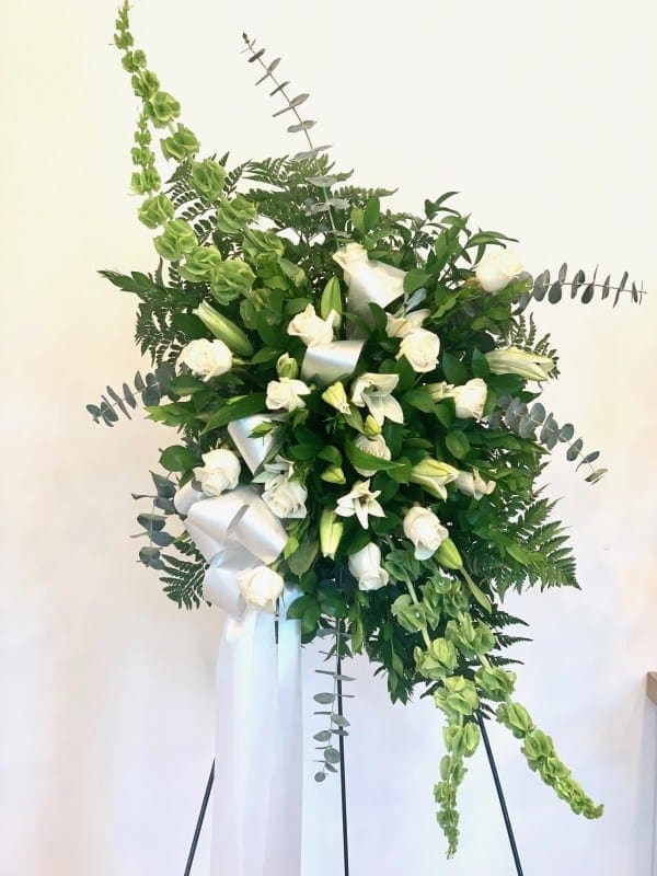 Sympathy Spray ™ - Classis sympathy spray of white Roses and Lillie’s combined with sophisticated greenery.  