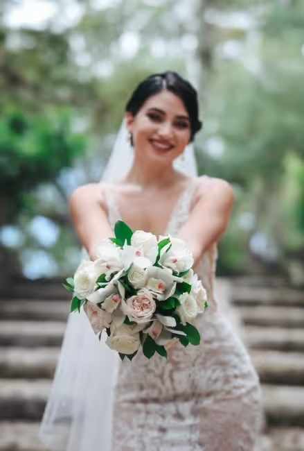 Bride holding a white and blush wedding bouquet