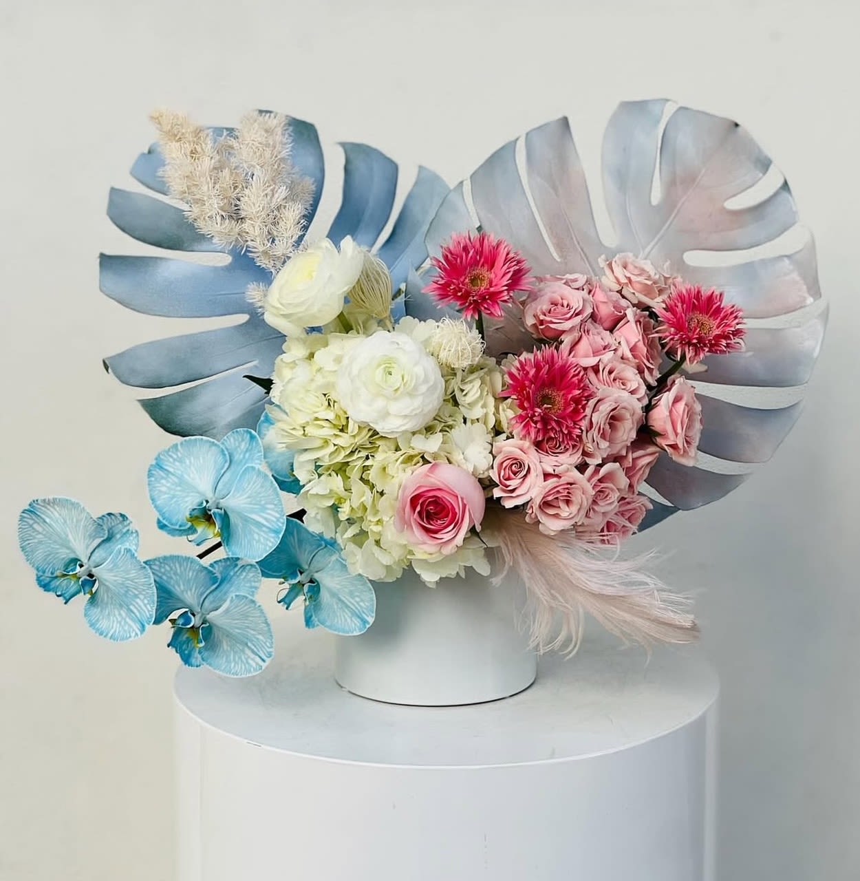 Pastel floral arrangement with pink and white blooms in a white vase