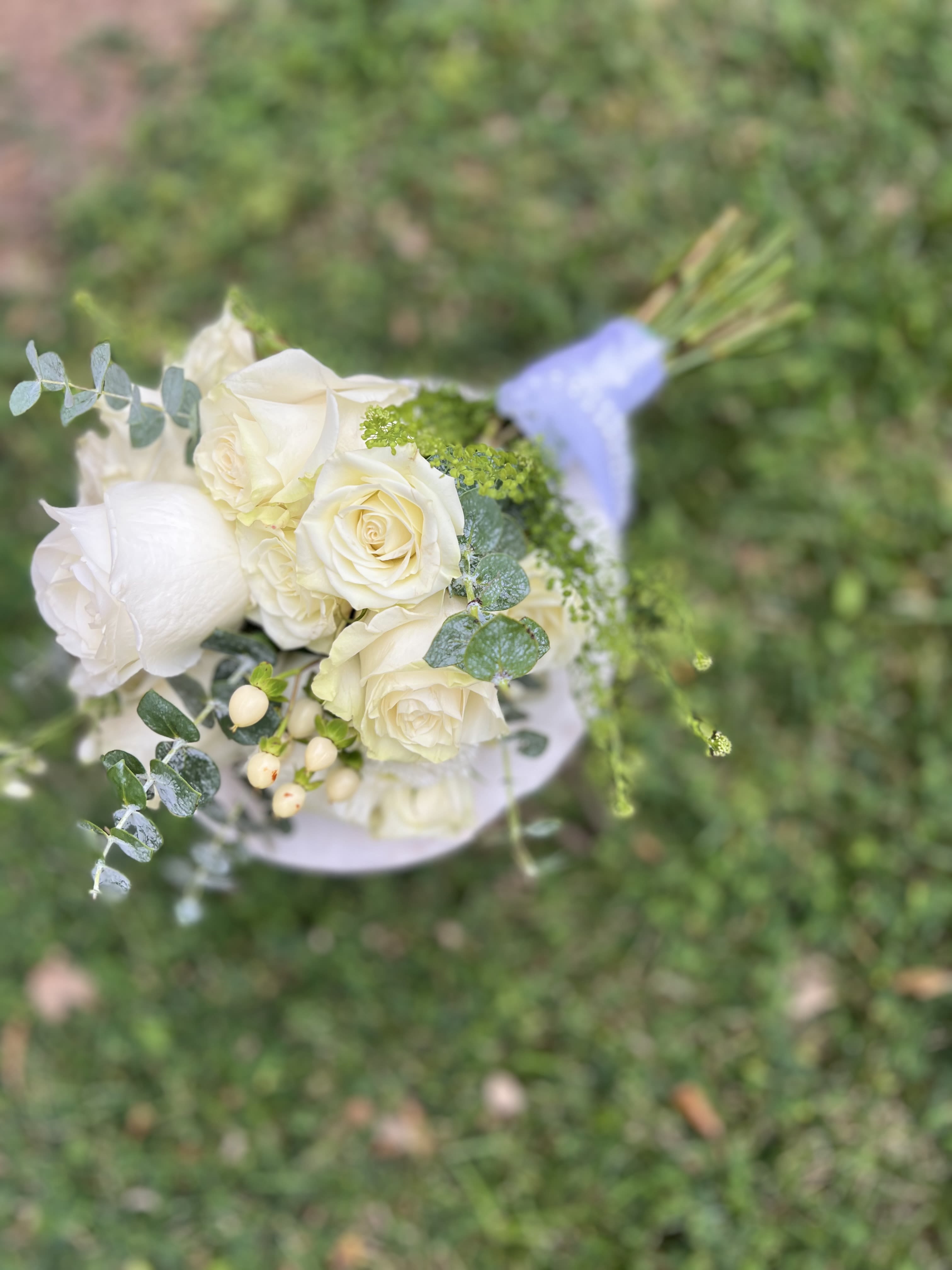 White rose bouquet with eucalyptus and small berries