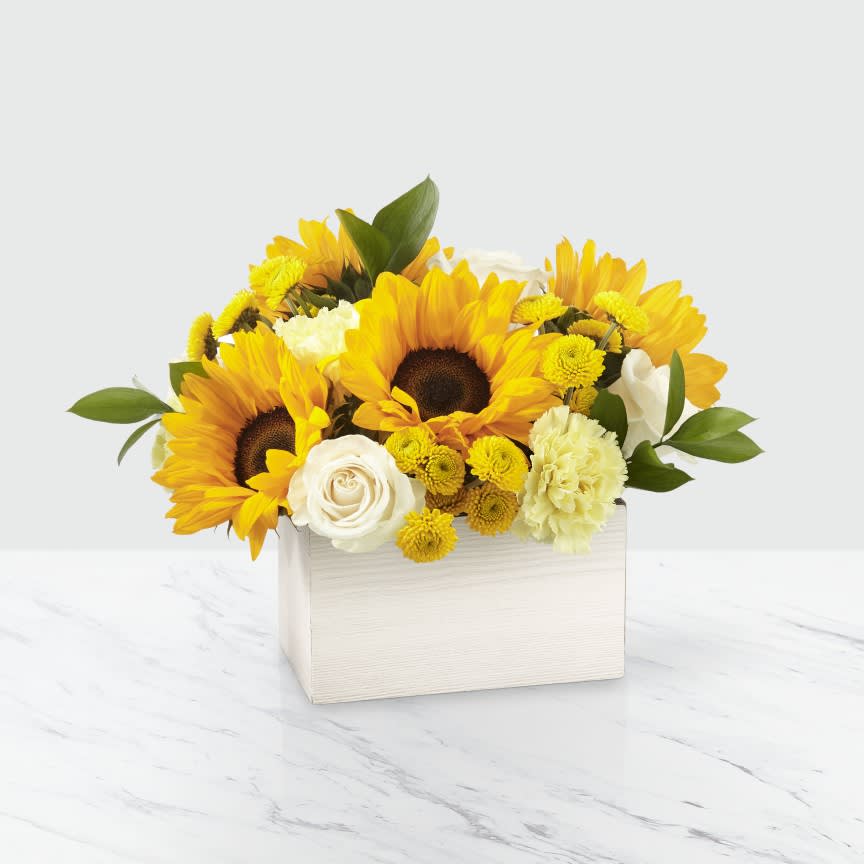 Sunflower and white rose arrangement in a white box