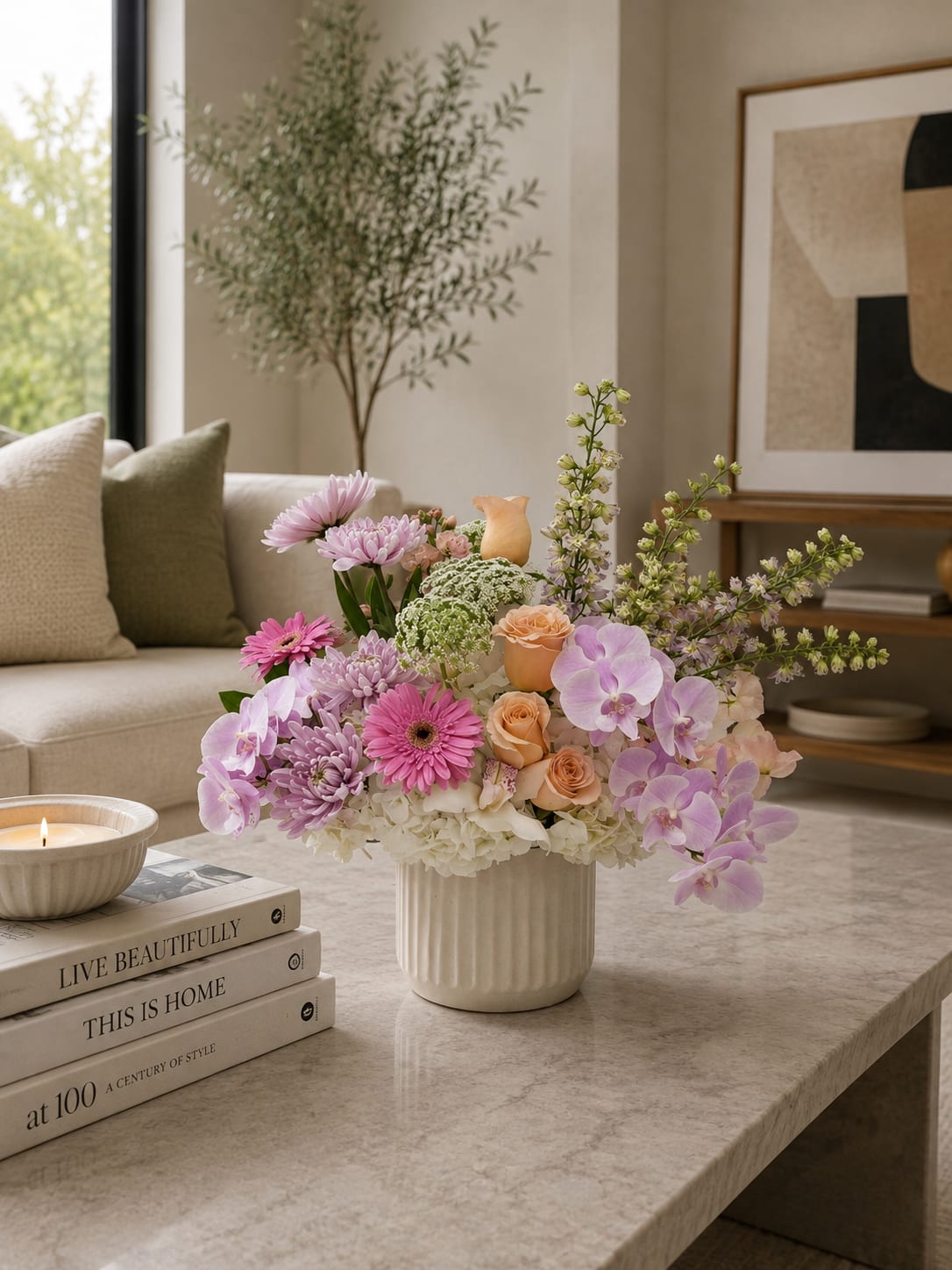 Pastel floral arrangement in a white vase with orchids, roses, and chrysanthemums