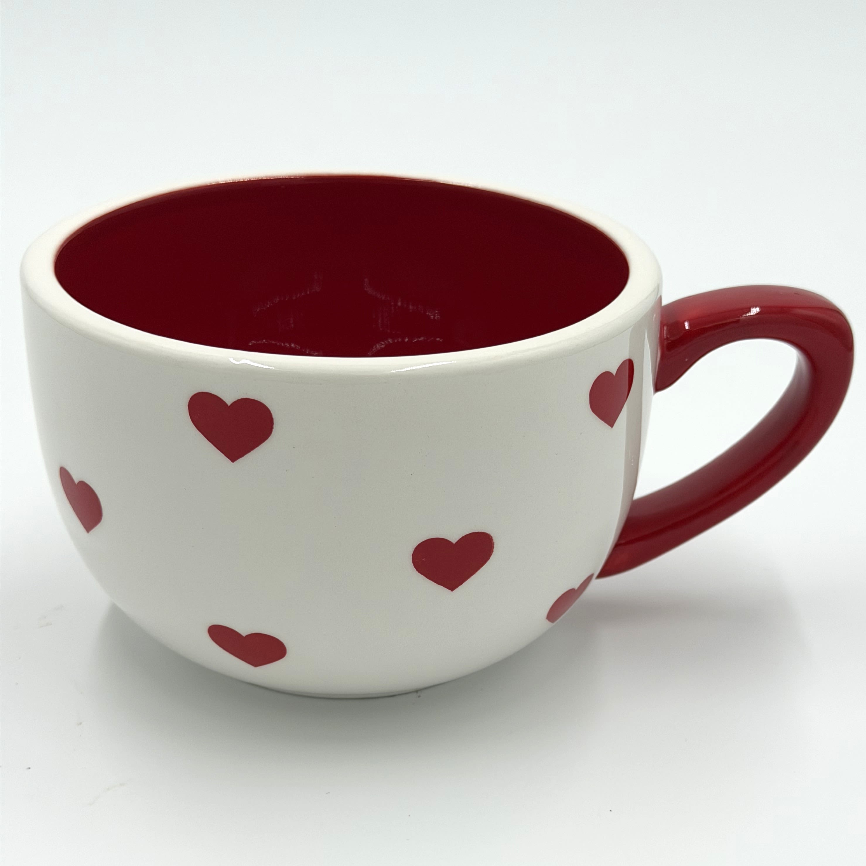 Heart Mug - This adorable heart-patterned mug is the perfect way to add a little love to every sip. Featuring a classic white finish with scattered red hearts, a bold red interior, and a matching handle, it brings a sweet and cozy touch to coffee, tea, or hot cocoa. Its charming design makes it a thoughtful gift for Valentine’s Day, anniversaries, or anyone who loves a little extra happiness in their daily routine.