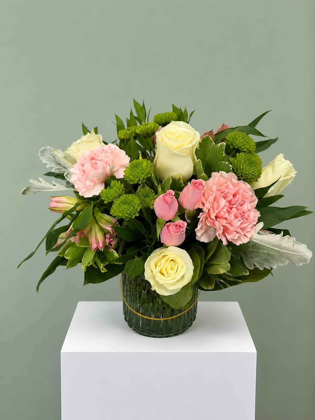 Garden Whisper - Garden Whisper is a fresh, garden-inspired floral arrangement featuring white roses, blush pink carnations, pink spray roses, green button chrysanthemums, alstroemeria, and premium seasonal greenery, thoughtfully designed in a modern glass vase. Its soft color palette and natural texture make it a beautiful choice for birthdays, get well wishes, sympathy, thank you gifts, anniversaries, or simply brightening someone's day.  Every Garden Whisper arrangement is handcrafted by the designers at All Occasions Florist using fresh, high-quality flowers. We carefully select each stem to create a balanced design while preserving the overall style shown. If a flower is unavailable due to seasonality or market conditions, we may substitute blooms of equal or greater value while maintaining the same color palette and look.  This arrangement includes a keepsake glass vase and is available for local flower delivery throughout Dallas, Highland Park, University Park, Oak Lawn, Uptown, Lakewood, Richardson, Plano, and many surrounding communities. Whether you're sending flowers to celebrate a special occasion or simply to let someone know you're thinking of them, Garden Whisper offers a timeless design that fits almost any moment.