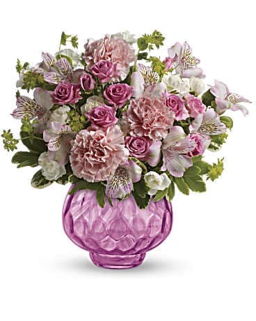 Pink and white mixed bouquet in a pink glass vase