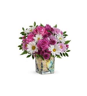 Pink roses and white daisies in a patterned square vase