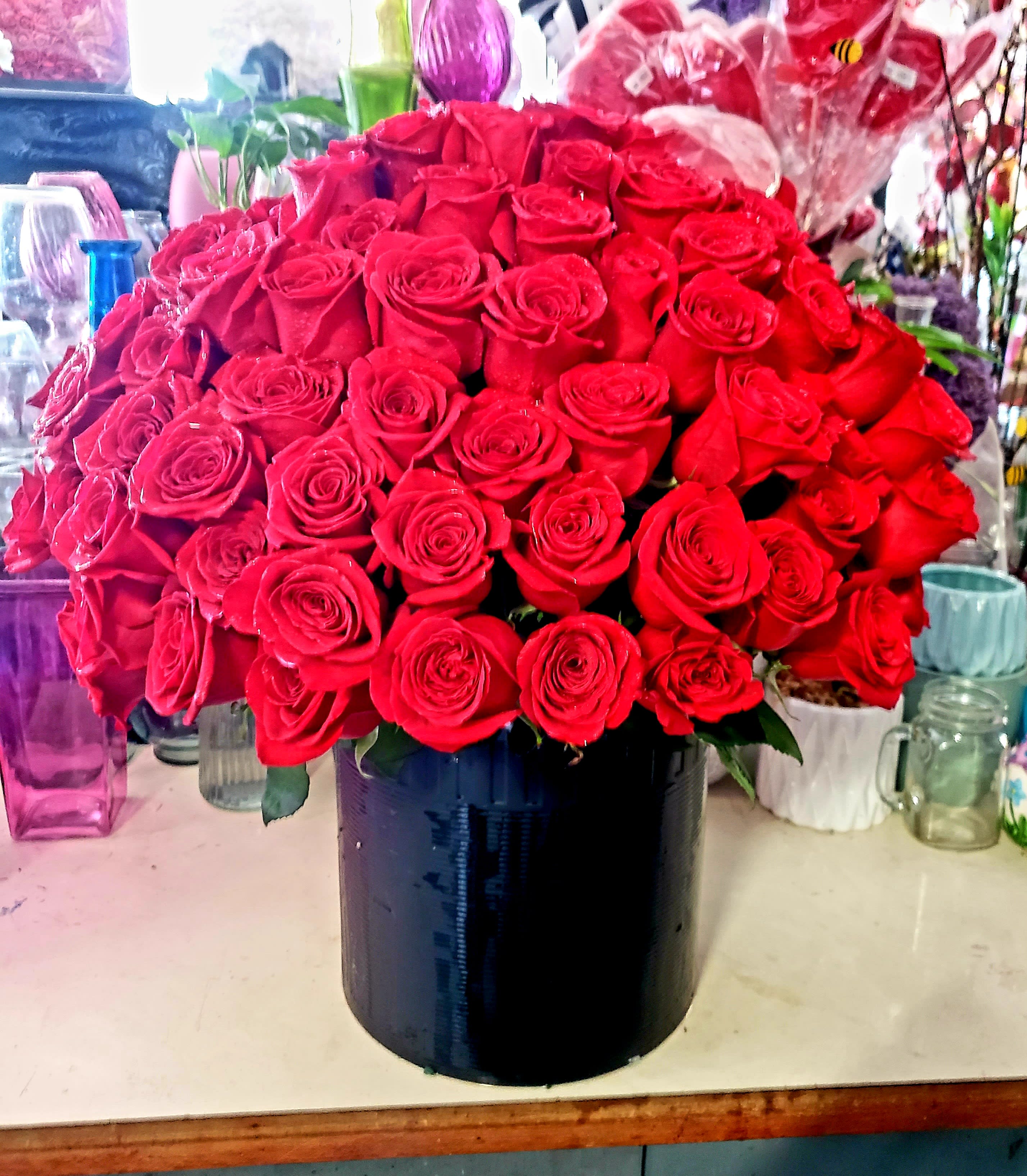 Large bouquet of red roses in a black vase