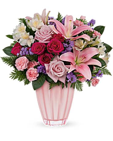 Dancing Beauty Bouquet - Dance into any occassion with this beautiful ballet pink surprise! Feminine roses and lilies brighten her special day in a keepsake vase of European glass with metallic finish. Pink roses, hot pink spray roses, white alstroemeria, pink asiatic lilies, miniature pink carnations and lavender sinuata statice are arranged with leatherleaf fern. Delivered in a Dancing Beauty vase.  