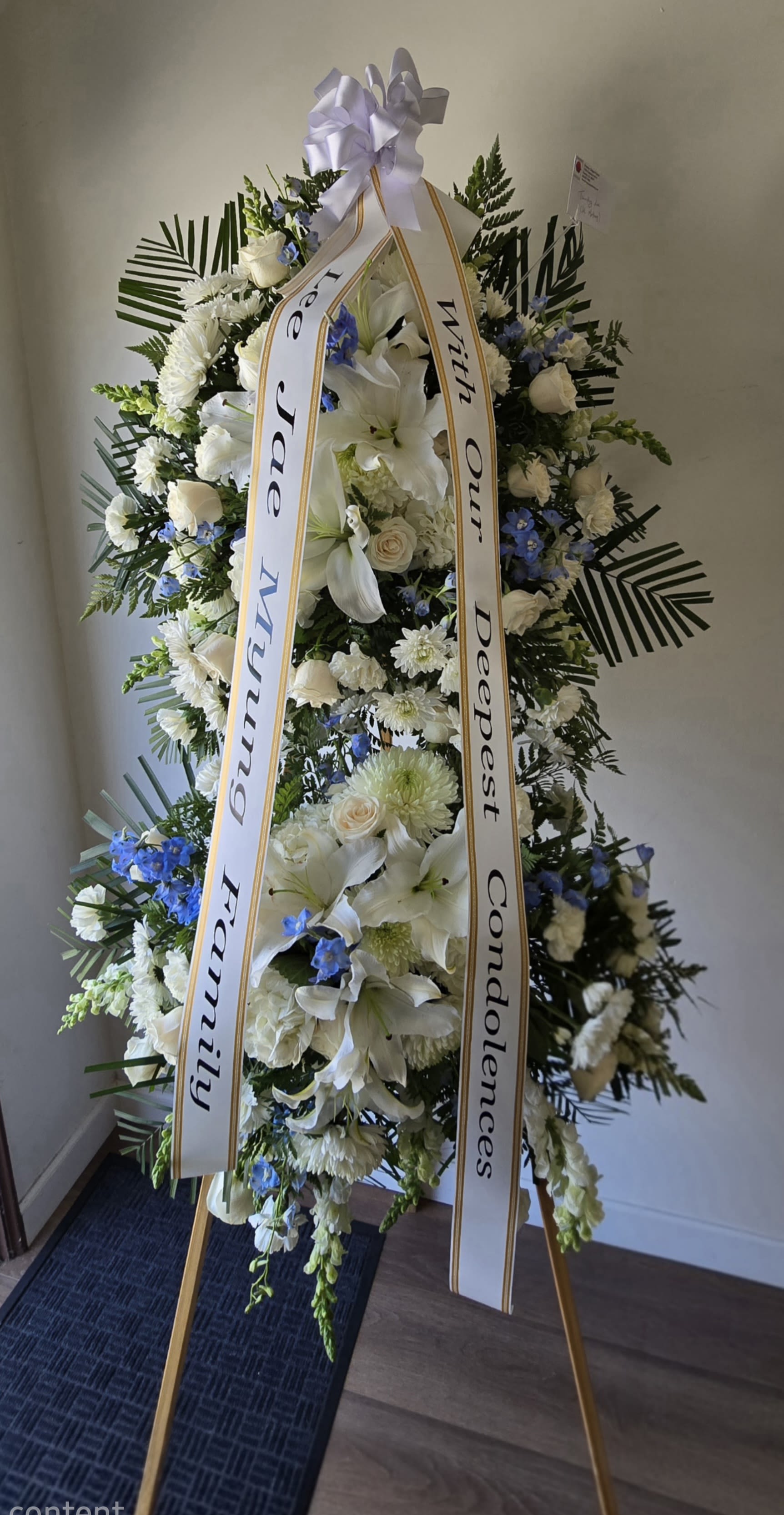 Korean Double Standing Spray - Traditional Korean style funeral spray encompassing two floral spray. The easel stands an impressive 6 ft. tall. If you desire an specific color theme please specify the colors in the special instruction box. Approximate overal demensions are (H) 6'6" (W) 40". Banners are available at no extra charge on this order.