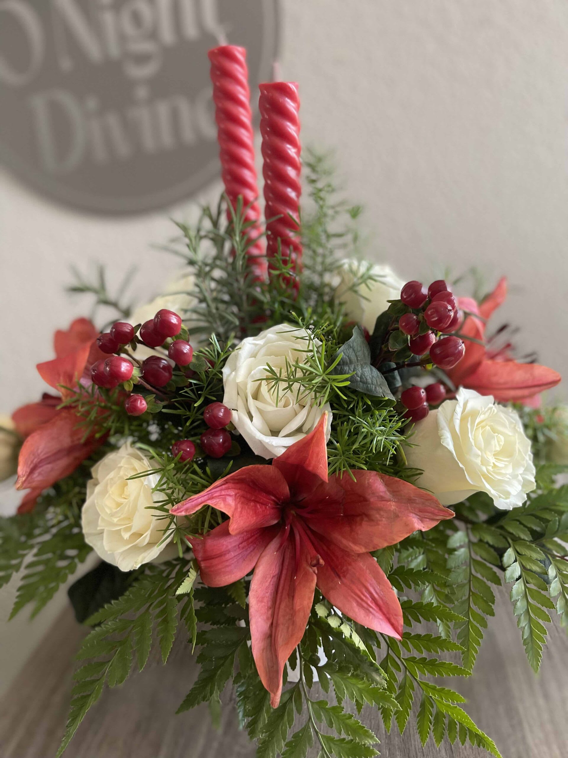 Red amaryllis and white roses with two pink candles