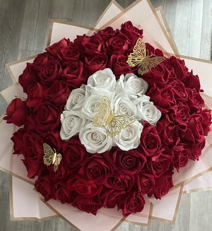 Bouquet of red and white roses with butterfly accents