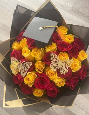 Bouquet of red and yellow roses with butterfly decorations and a graduation cap