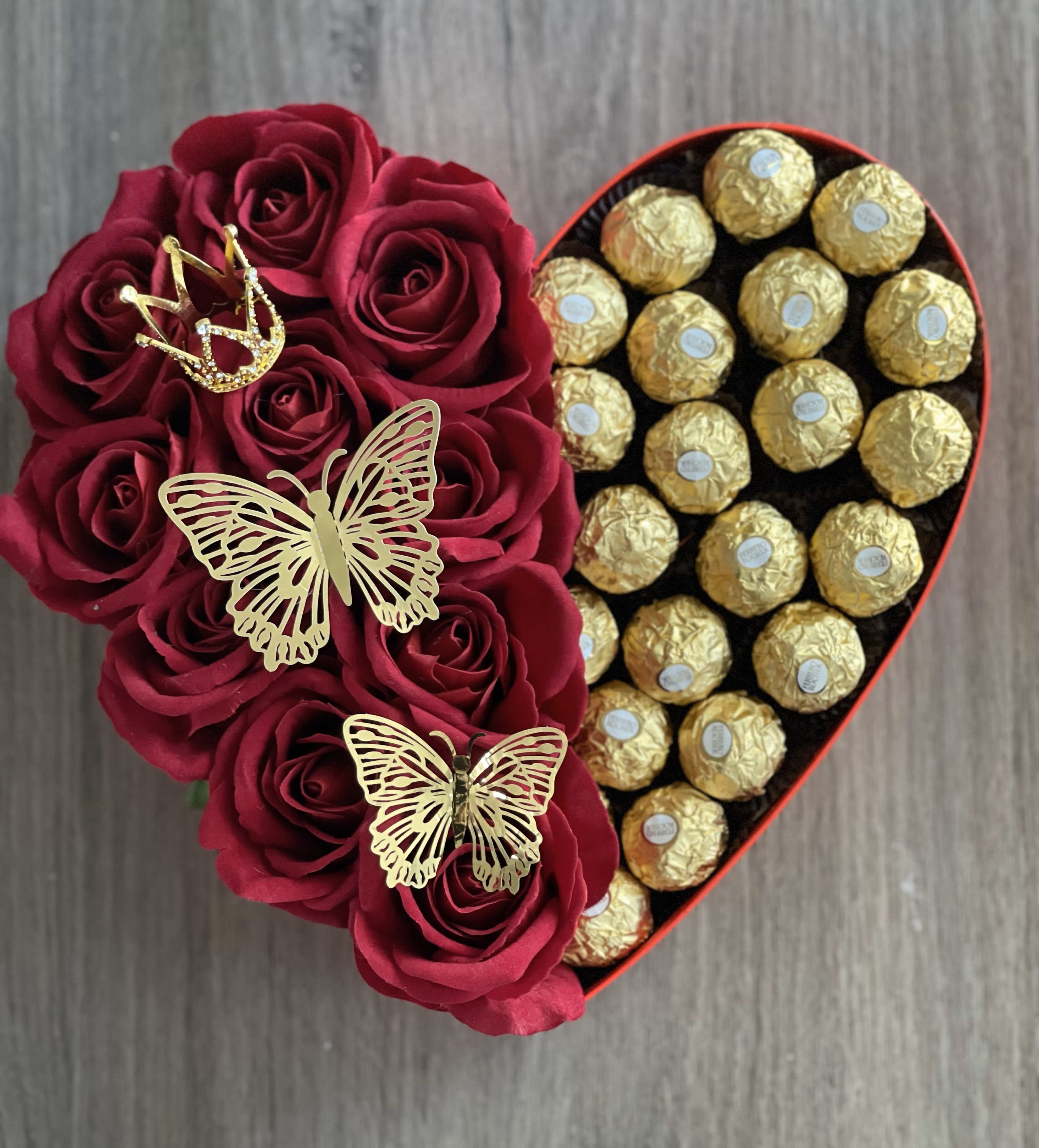 Heart-shaped box with red roses and gold-wrapped chocolates