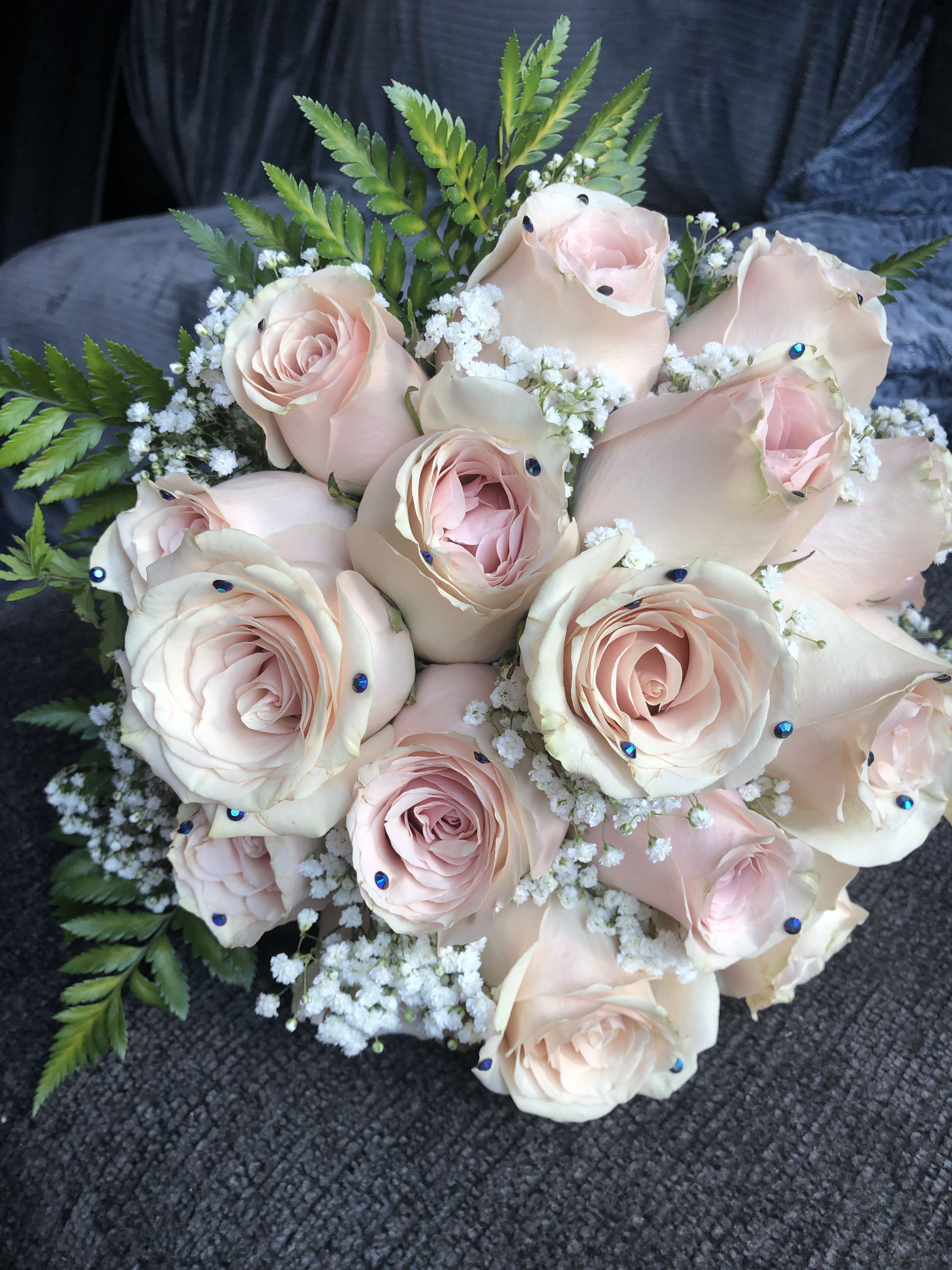Bouquet of pale pink roses with baby's breath and fern foliage
