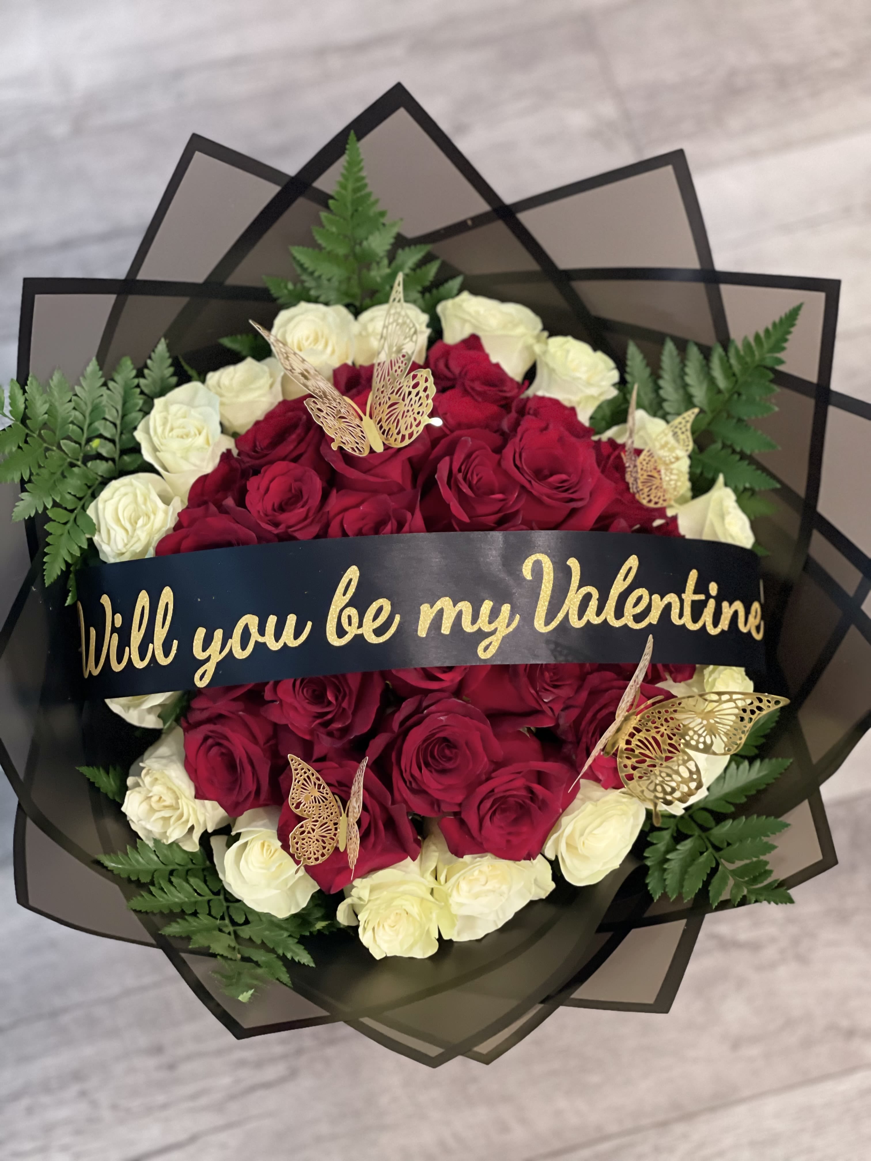 Bouquet of red and white roses with a Valentine ribbon