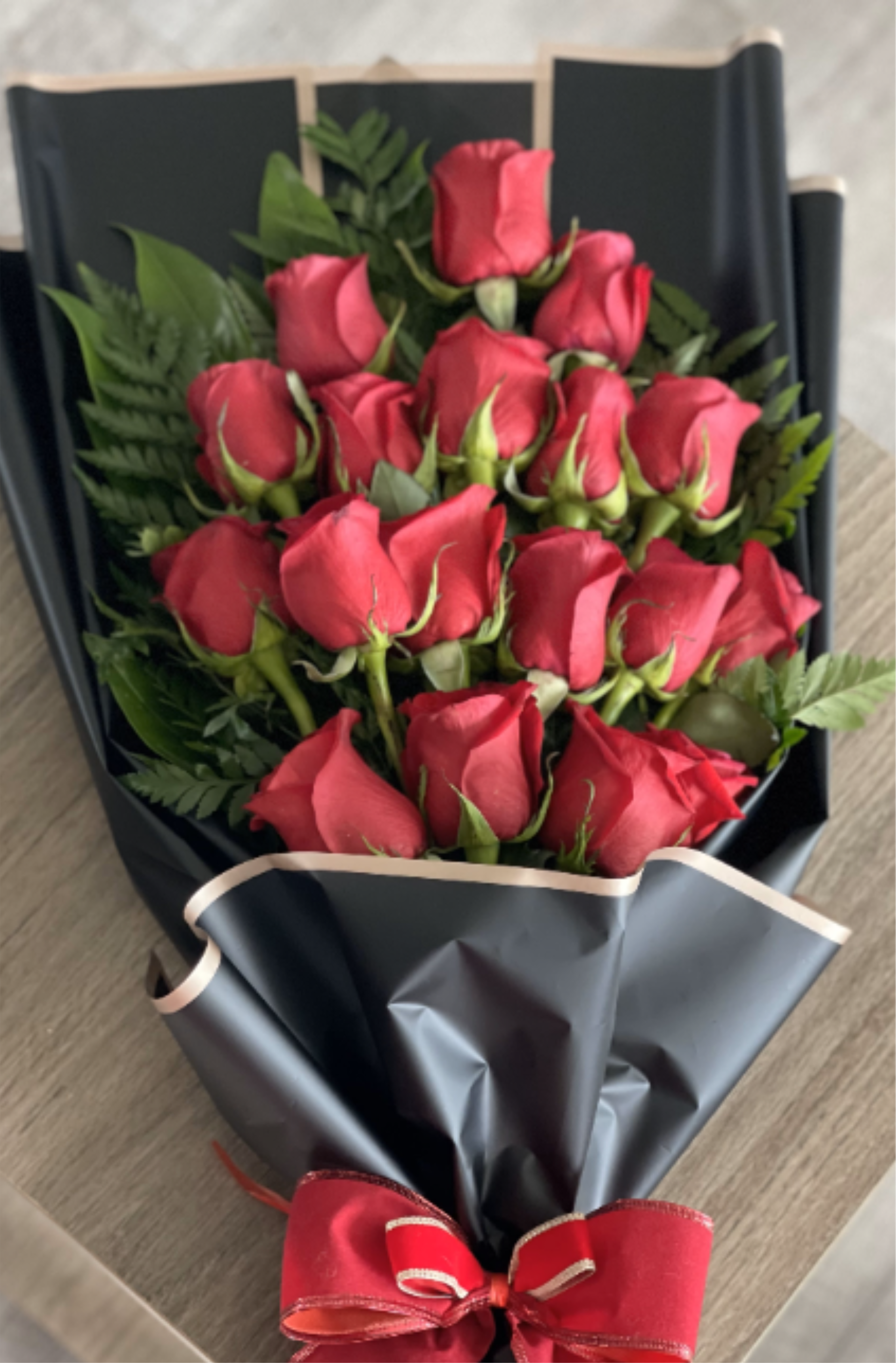 Bouquet of 18 Red Roes and  Greenery - Delightful bouquet of 18 red roses with leather leaves wrapped with waterproof paper and an elegant bow.