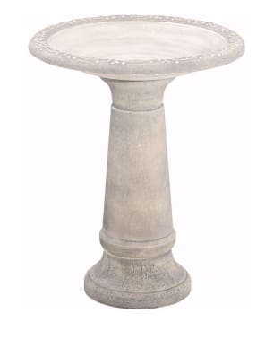 Stone pedestal birdbath with a shallow round basin