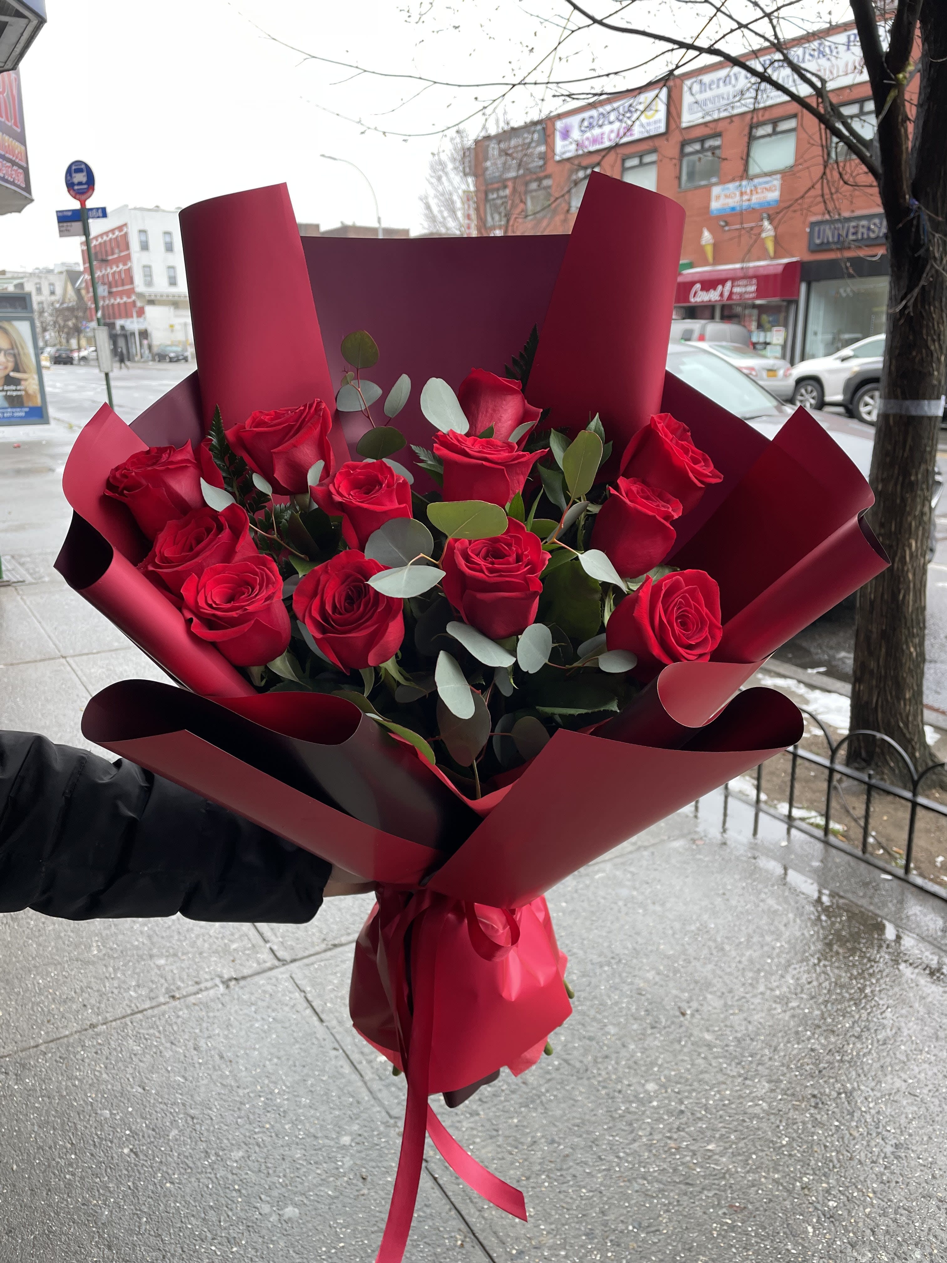Bouquet of red roses wrapped in burgundy paper