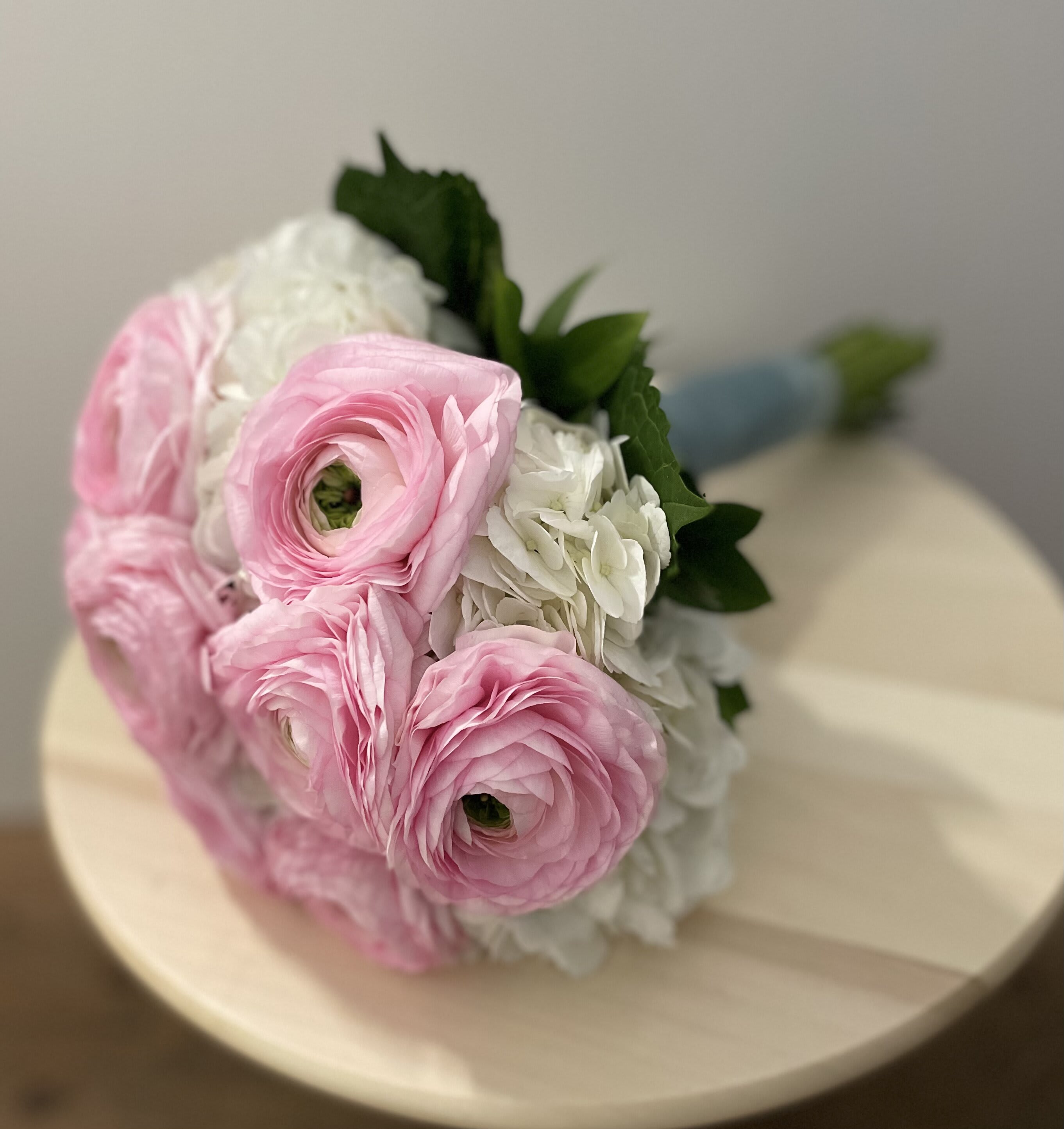 Bouquet of pink and white flowers with green leaves