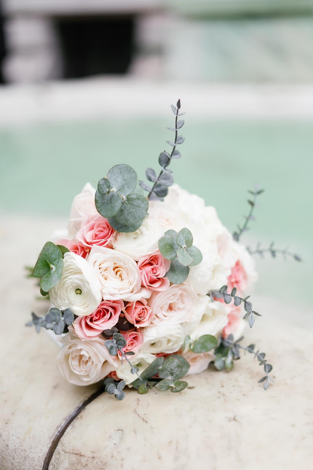 Round bouquet of white and pink roses with eucalyptus