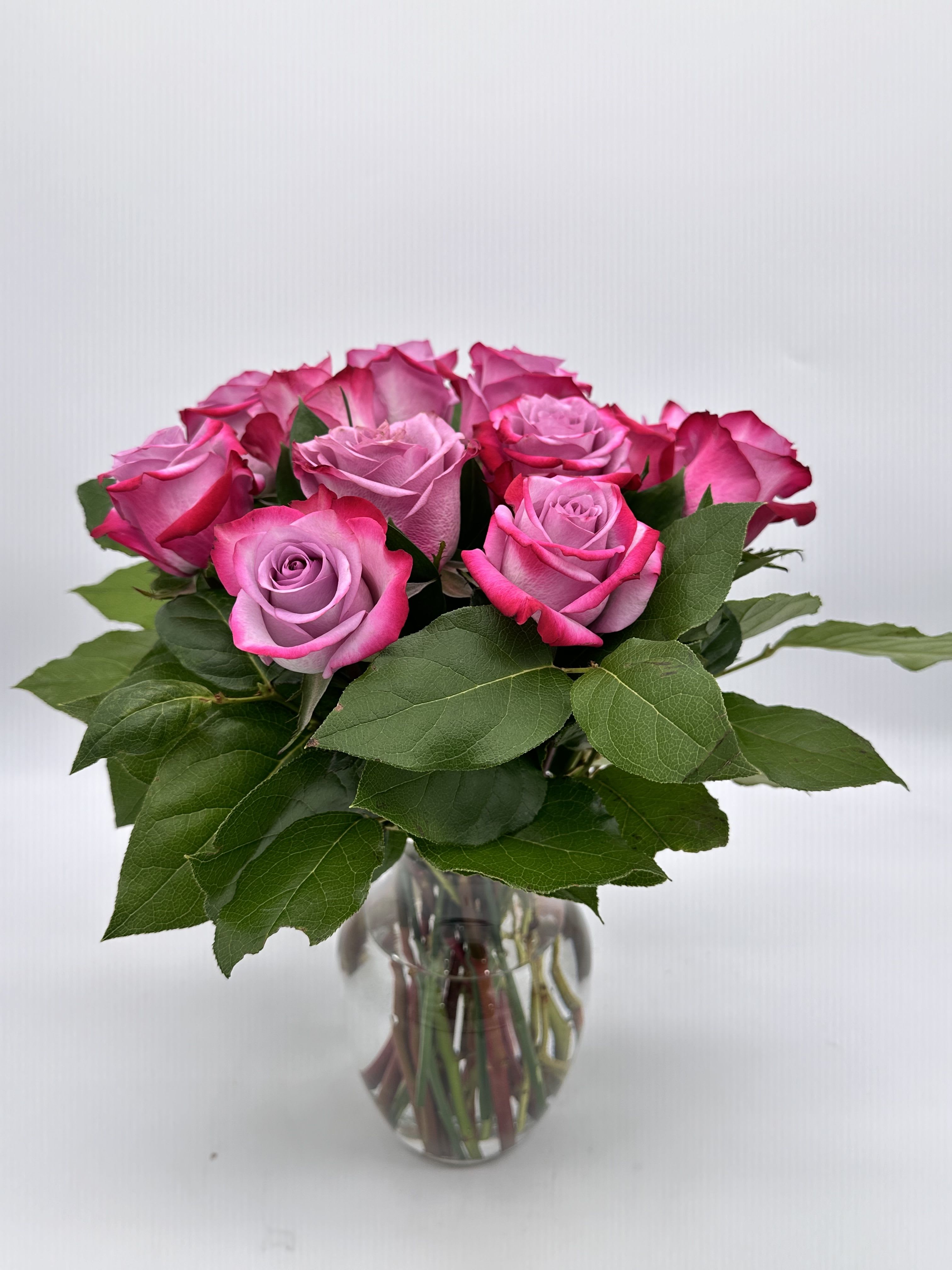 Pink roses arranged in a clear glass vase