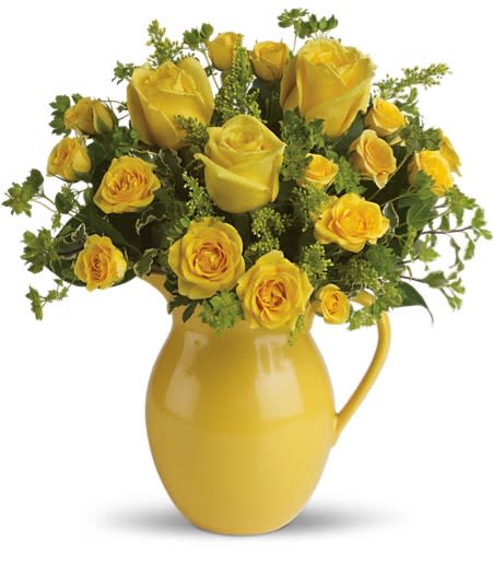 Yellow roses arranged in a yellow pitcher vase