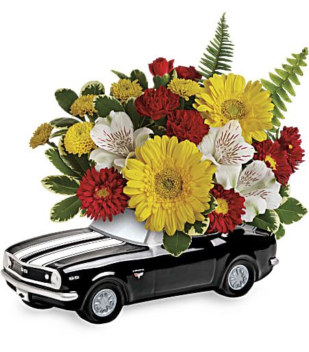 Flower arrangement in a black toy car container