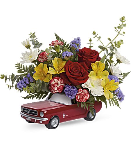 Flower arrangement in a red pickup truck container