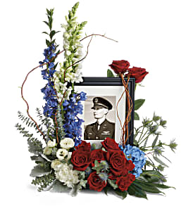 Memorial floral frame with red roses, blue and white flowers, and a portrait