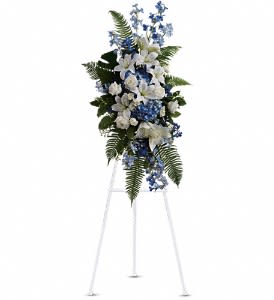 Tall blue and white floral standing spray on an easel