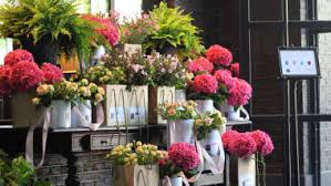 Display of colorful flower bouquets in buckets outside a shop