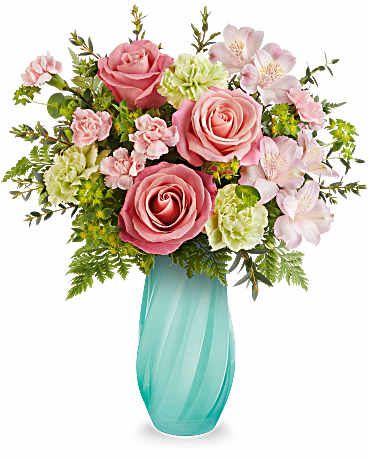 Pink roses and pale flowers in a turquoise vase