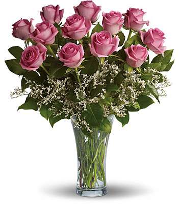 Pink roses arranged in a clear glass vase