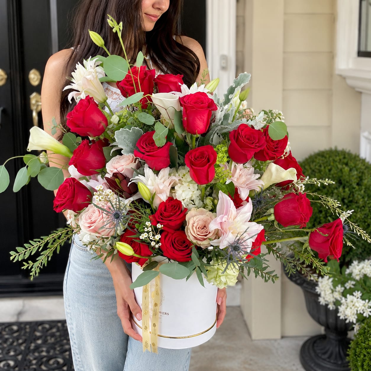 Large bouquet of red and white roses in a white hat box