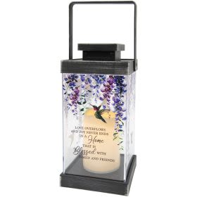 Lantern "Love overflows" - This LED lantern has a hummingbird and floral image and the message "Love overflows and jy never ends in home that is blessed with family and friends". Dimension W: 5.5" H: 13" D: 5.5"
