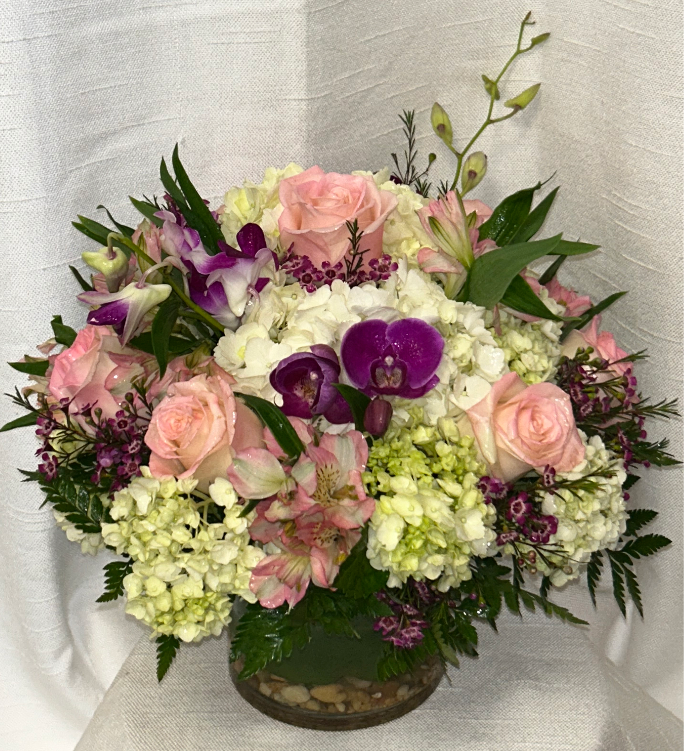 Happiness (DL) - Introducing our modern and elegant Leaf Lined Hydrangea and Rose Arrangement, expertly handcrafted by our own talented artisans. This exquisite floral masterpiece is designed to captivate and delight.  
