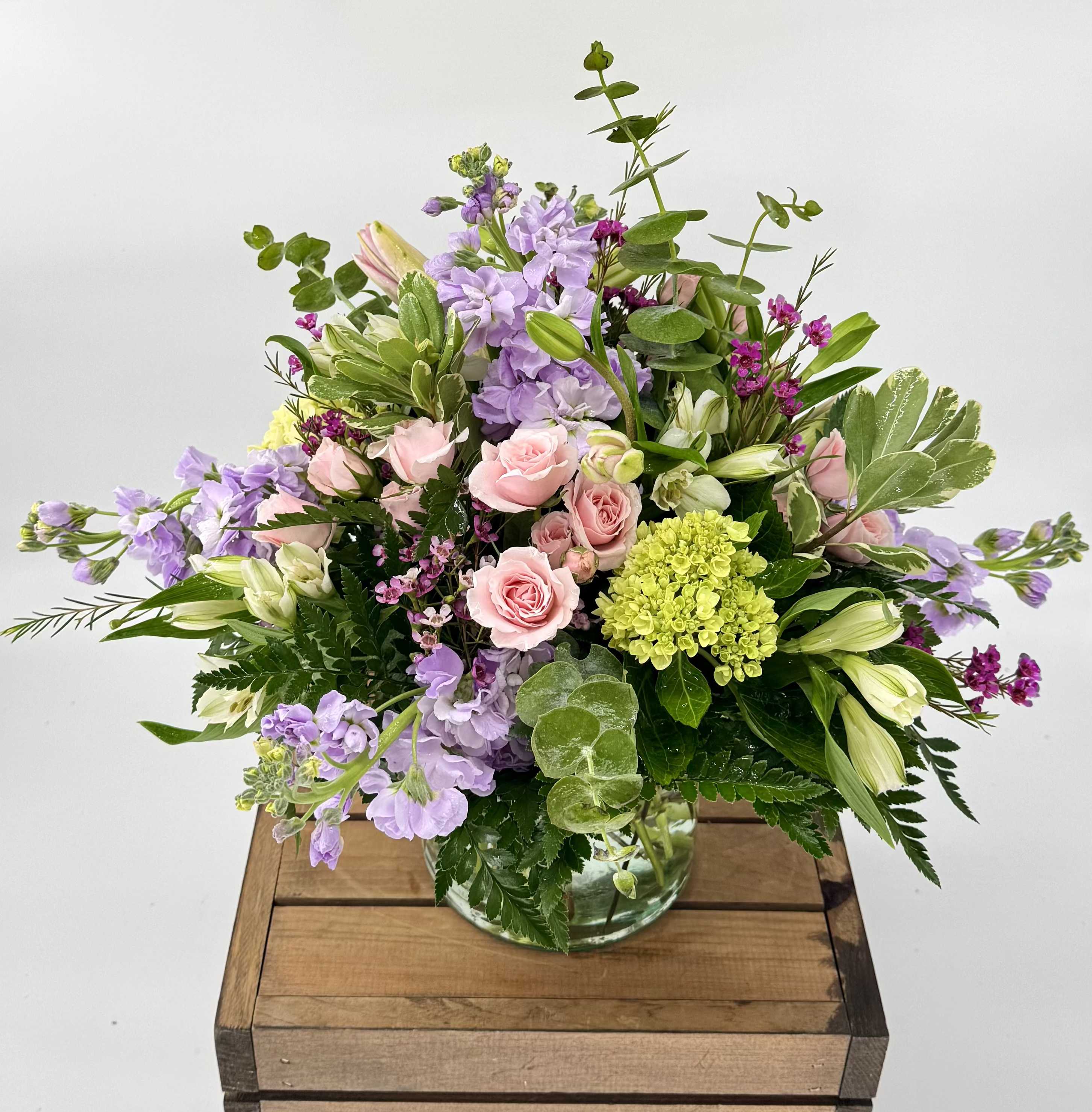 Delighted in Delray (DL) - The Delighted in Delray floral arrangement is a burst of vibrant color, featuring a captivating combination of lilies, stock, hydrangea, spray roses, and gerberas. Set in a stunning glass vase adorned with shades of pink, green, and orange, this arrangement is a true feast for the eyes.  