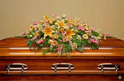 Heavenly Blooms Casket Spray (DL) - Create a vibrant and uplifting tribute with our casket spray cover adorned with a stunning combination of orange lilies, orange gerbera daisies, orange carnations, orange mini spray roses, pink stock, and lush greenery. This exquisite arrangement is a celebration of life, bringing warmth, energy, and vivid colors to honor your beloved.