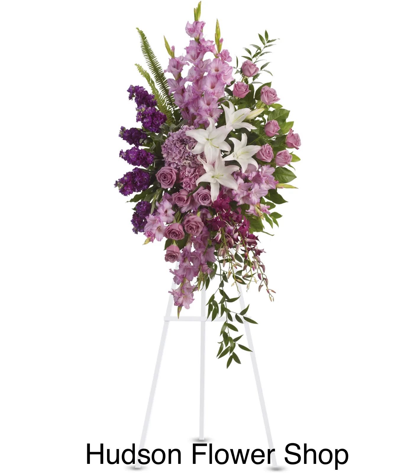 Tall purple and white floral standing spray on a white easel