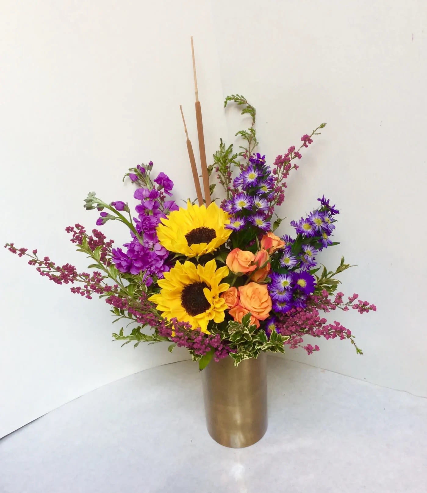 Helpful Sunflower - Think of Spring with this cheerful arrangement of sunflowers, stock and other colorful accent flowers.  