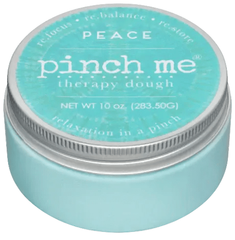 A turquoise jar labeled "pinch me therapy dough" with a silver lid
