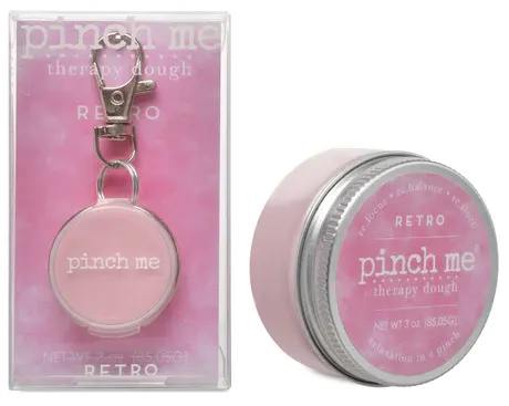 Pink therapy dough tin and matching keychain in clear packaging