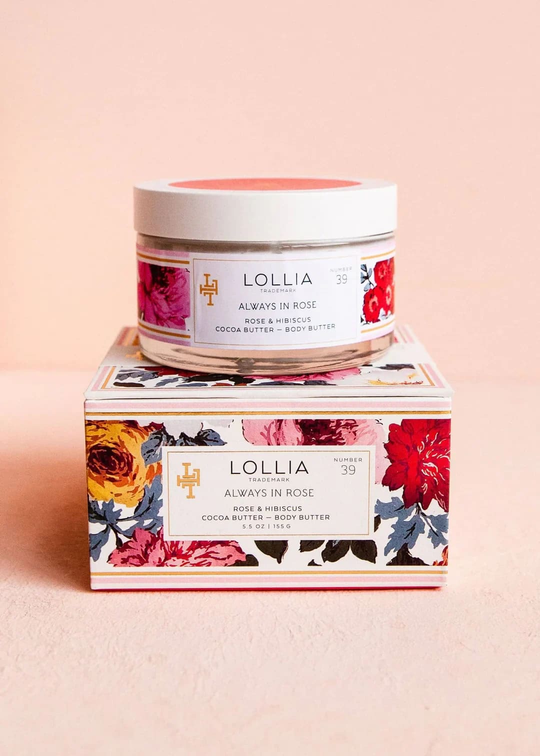 Jar of rose body butter on a floral-patterned box