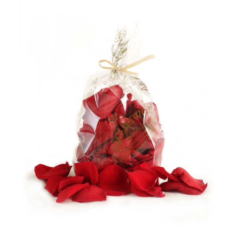 Clear gift bag filled with red rose petals and tied with a ribbon