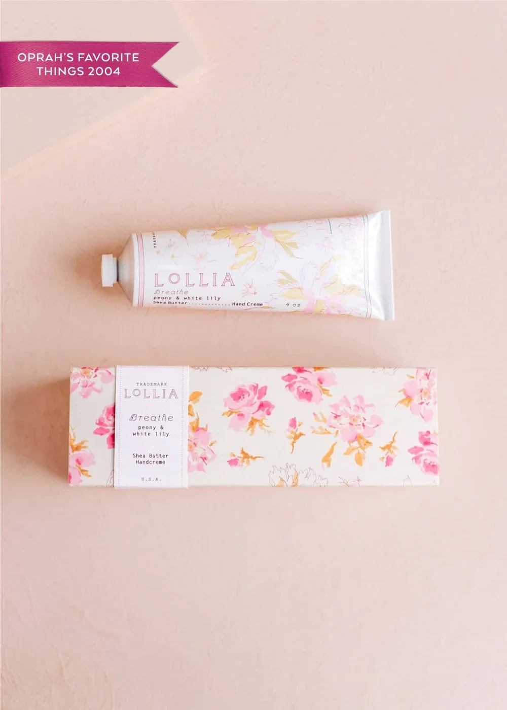 Hand cream tube and floral box on a pale pink background