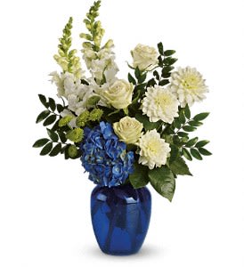Ocean Devotion - Sending this brilliant blue and white bouquet will surely garner oceans of appreciation from whoever receives it.  Dazzling blue hydrangea, green roses and button spray chrysanthemums, divine white dahlias and snapdragons plus huckleberry arrive in a striking cobalt vase.  Approximately 14" W x 20" H  Orientation: One-Sided 