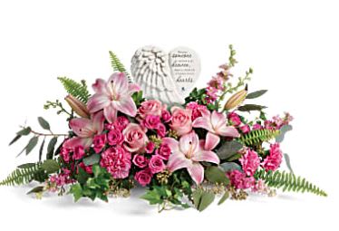 Heartfelt Farewell - A heartfelt celebration of a truly special life, this magnificent bouquet of pink roses and lilies beautifully surrounds a touching porcelain keepsake they'll treasure forever.